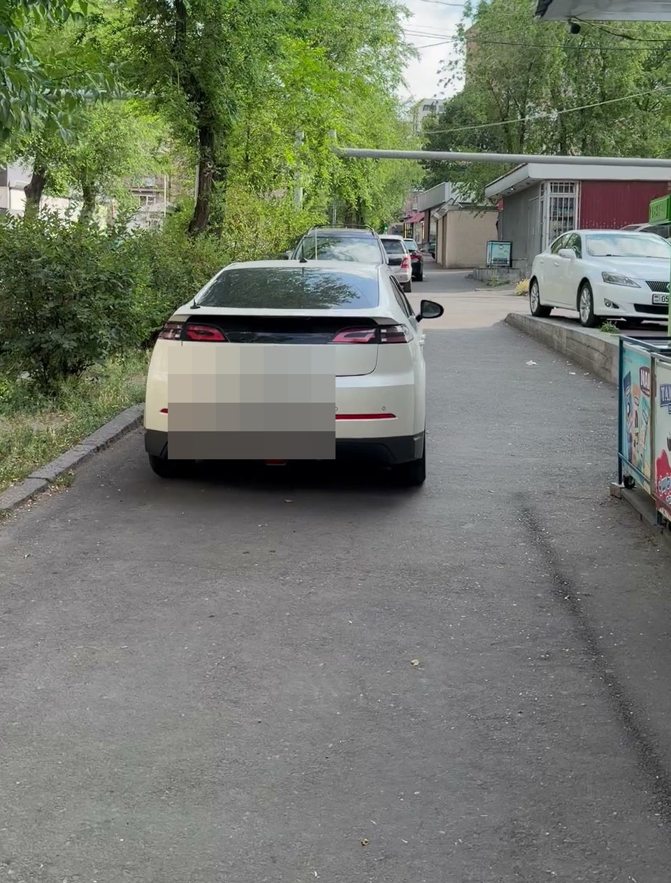 A single clip panning past many parked cars along a lane
